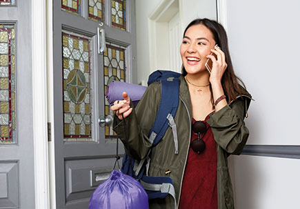 Woman on mobile leaving the house.  Woman on mobile leaving the house.